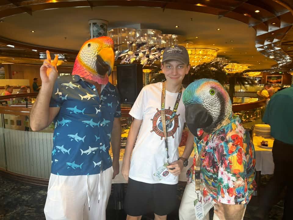 Parakeet Paradise, a young Parrothead with two parrot-mask characters